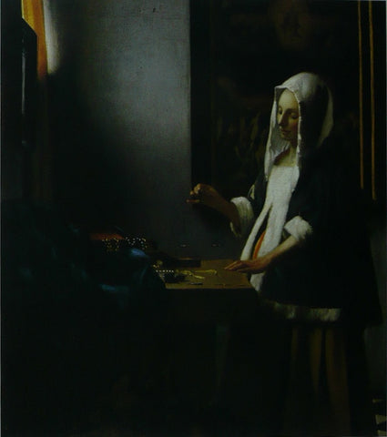 Woman holding a balance Vermeer