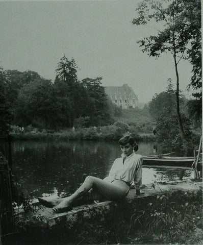 Audrey Hepburn posing by a lake 