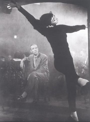 Audrey Hepburn dancing with Fred Astaire in background black & white