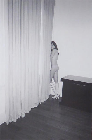 Nude female in white boots by curtains in a room (Glamour) (black & white)