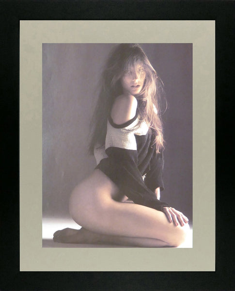 Brunette with long hair, kneeling in black & white jumper (Glamour)