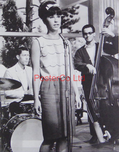 Astrud Gilberto standing at a Microphone